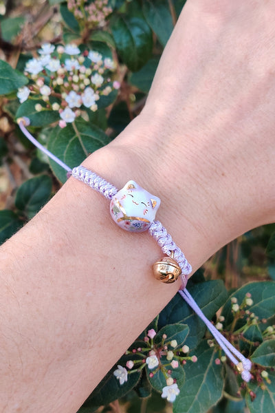 bracelet chat maneki neko en porcelaine violet, porté au poignet